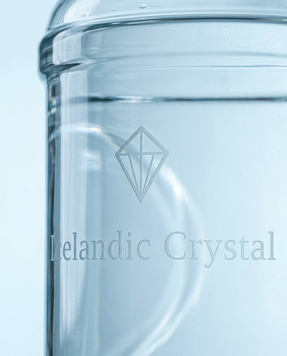 Close-up of the frosted Icelandic Crystal logo etched into a clear glass bottle (illustrative)